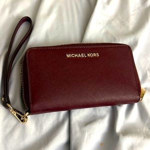Red wine color Michael Kors wristlet bag